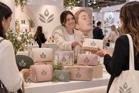 Personalised cosmetic bags displayed at a cosmetics trade stand